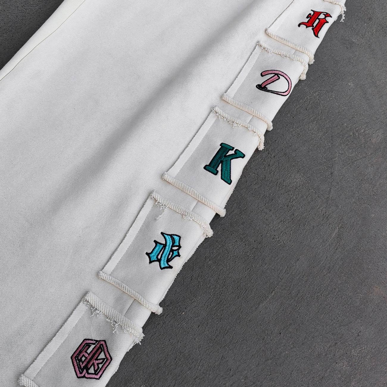 Gothic Letter Patch Sweatpants - White Distressed Multi Color Y2K Streetwear