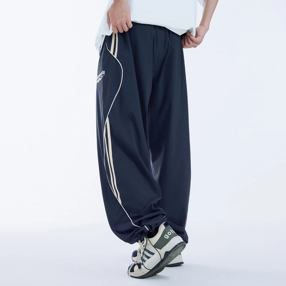 Huilin Wholesale New Trend Relaxed Fit Unisex High Street Sportswear Pants Custom Logo Printed Men Baggy Wide Leg Track Pants