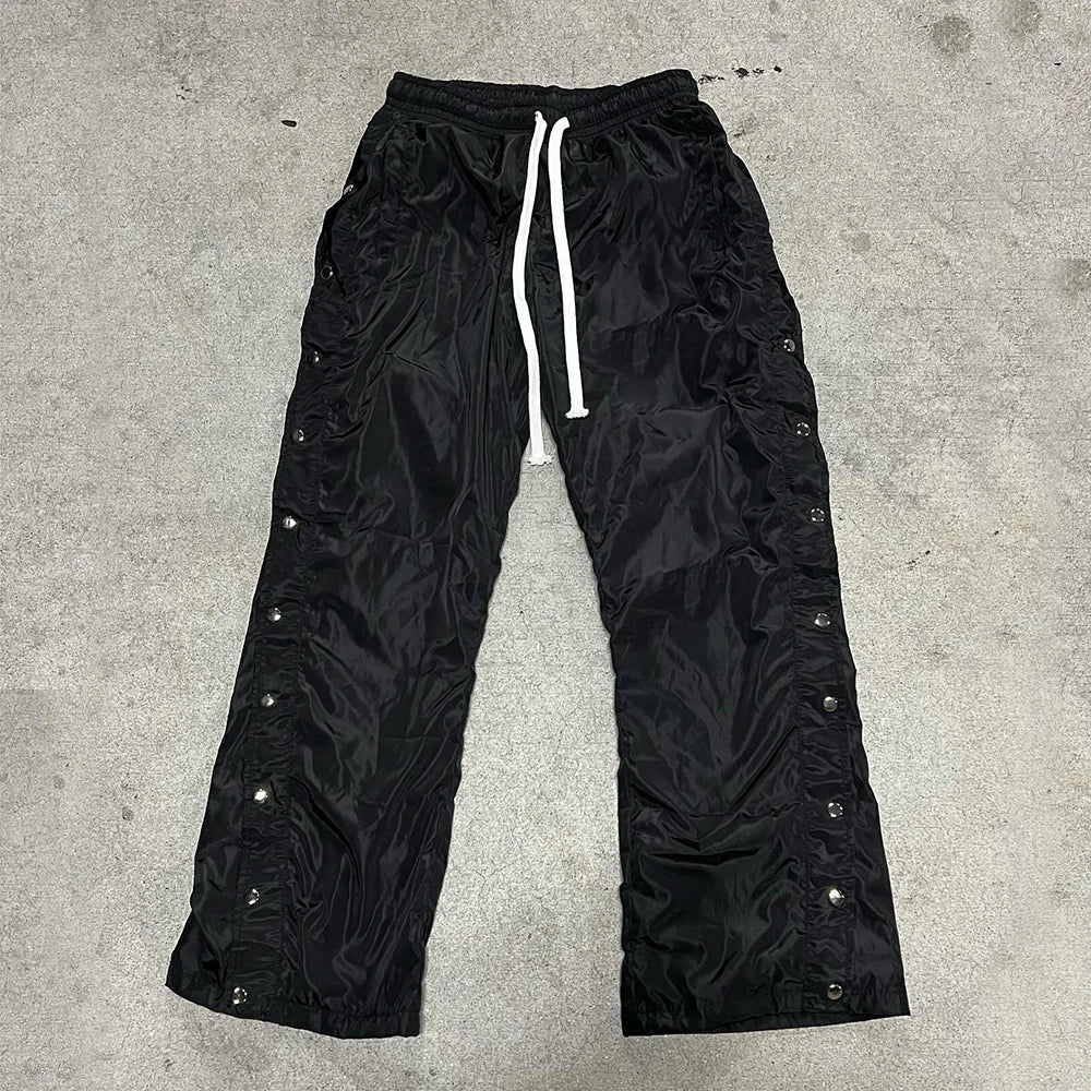 Huilin Wholesale Solid Color Blank Streetwear Nylon Pants Elastic Waist Men Custom Snap Button Side Wide Leg Track Pants